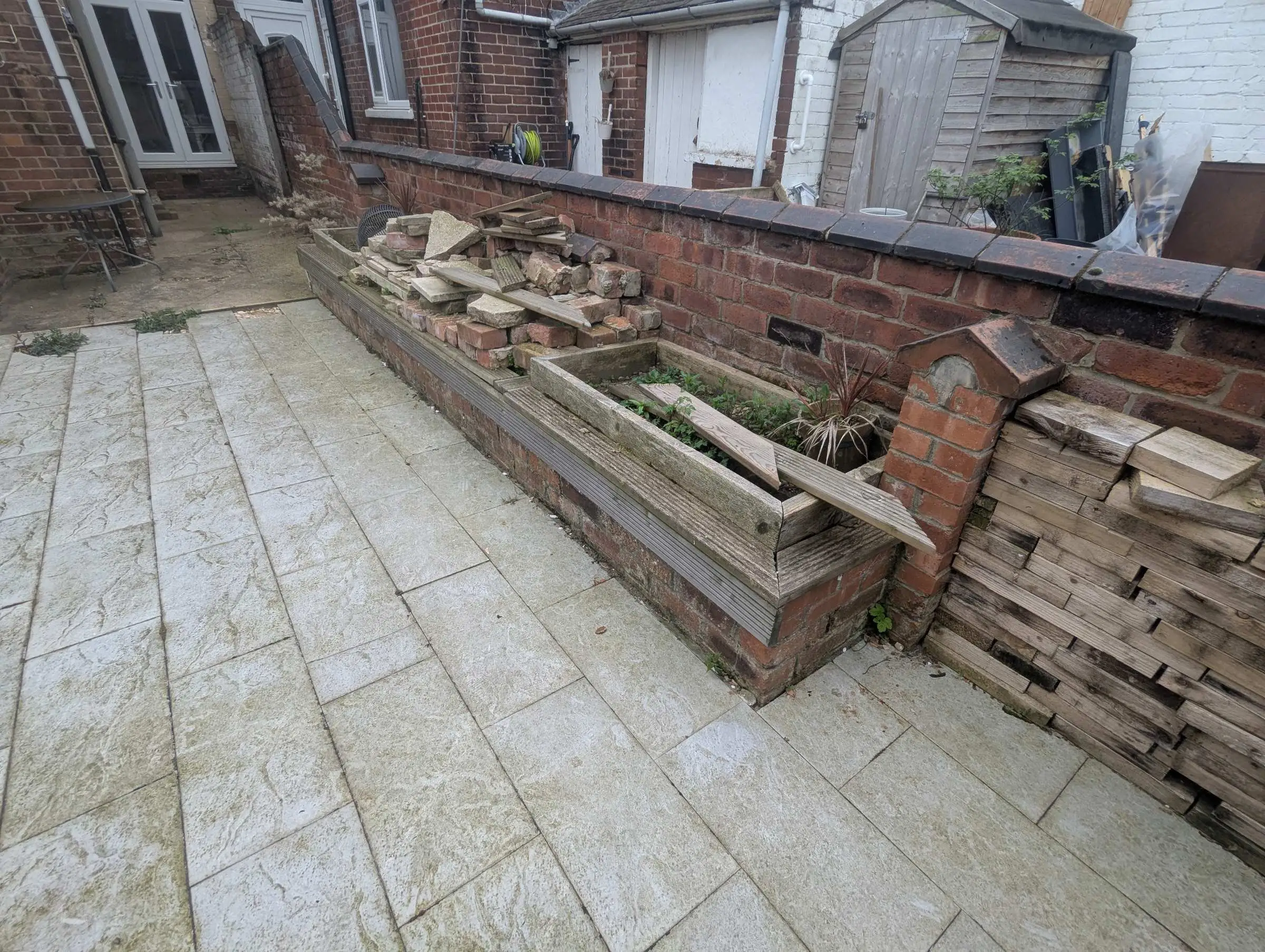 Dilapidated brick and timber planter