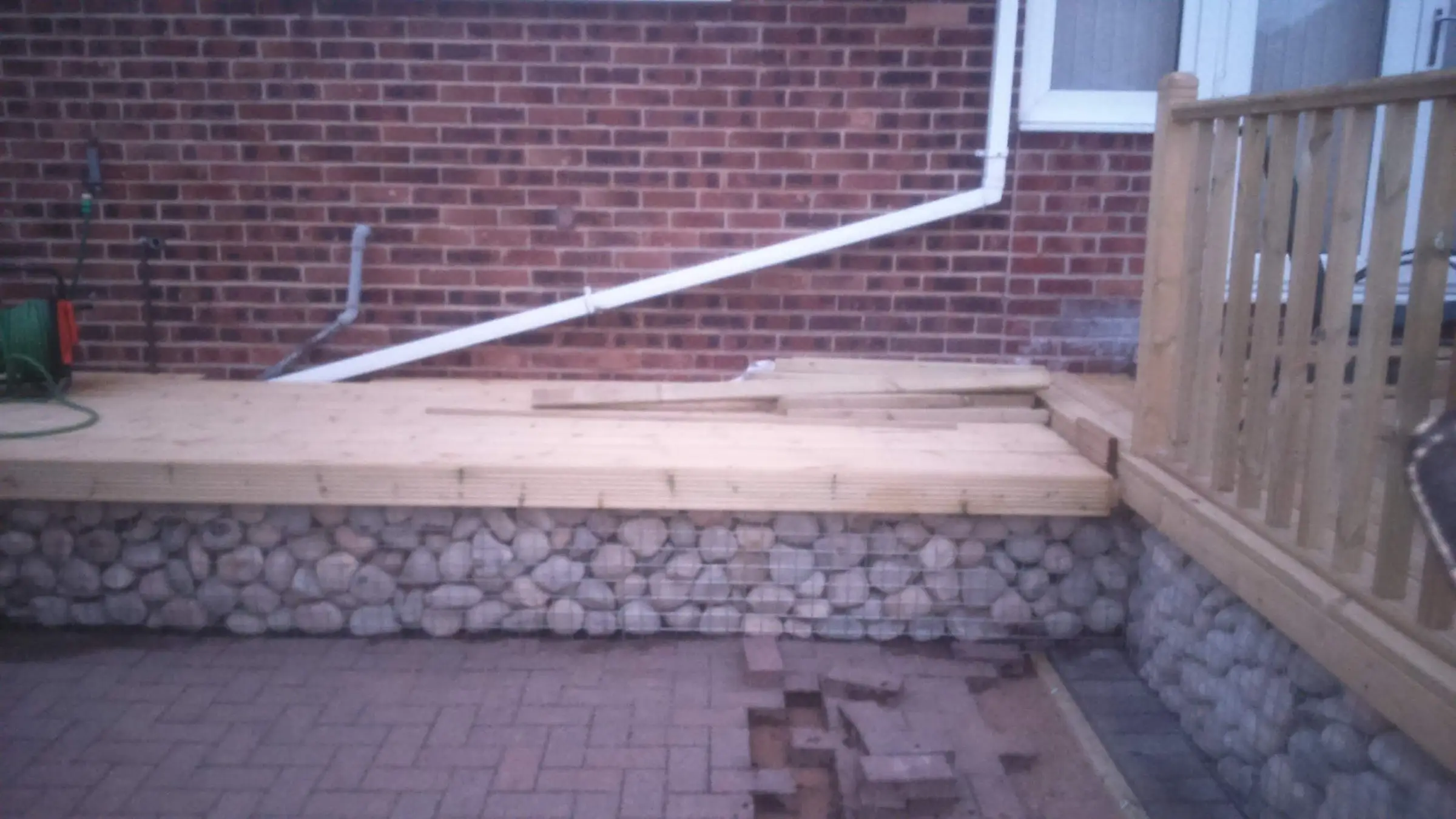 Decking with gabion detail, lawn reinstated and raised sleeper planters