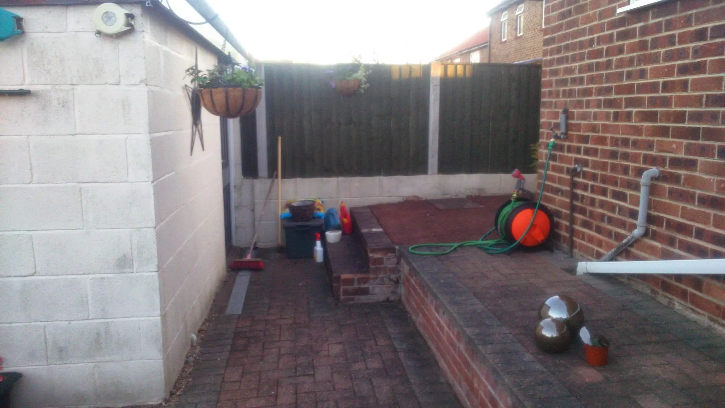 Decking with gabion detail, lawn reinstated and raised sleeper planters