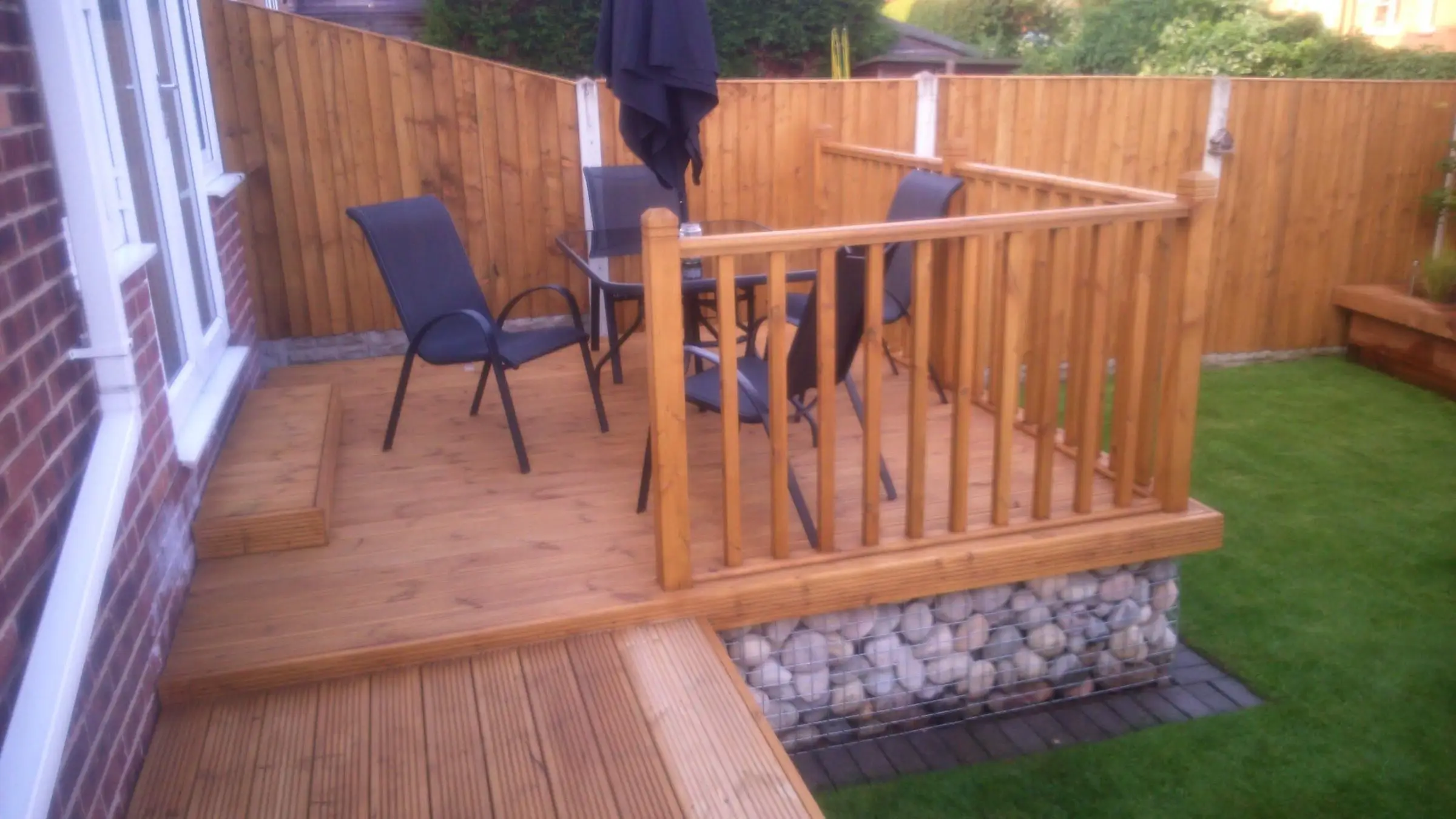 Decking with gabion detail, lawn reinstated and raised sleeper planters