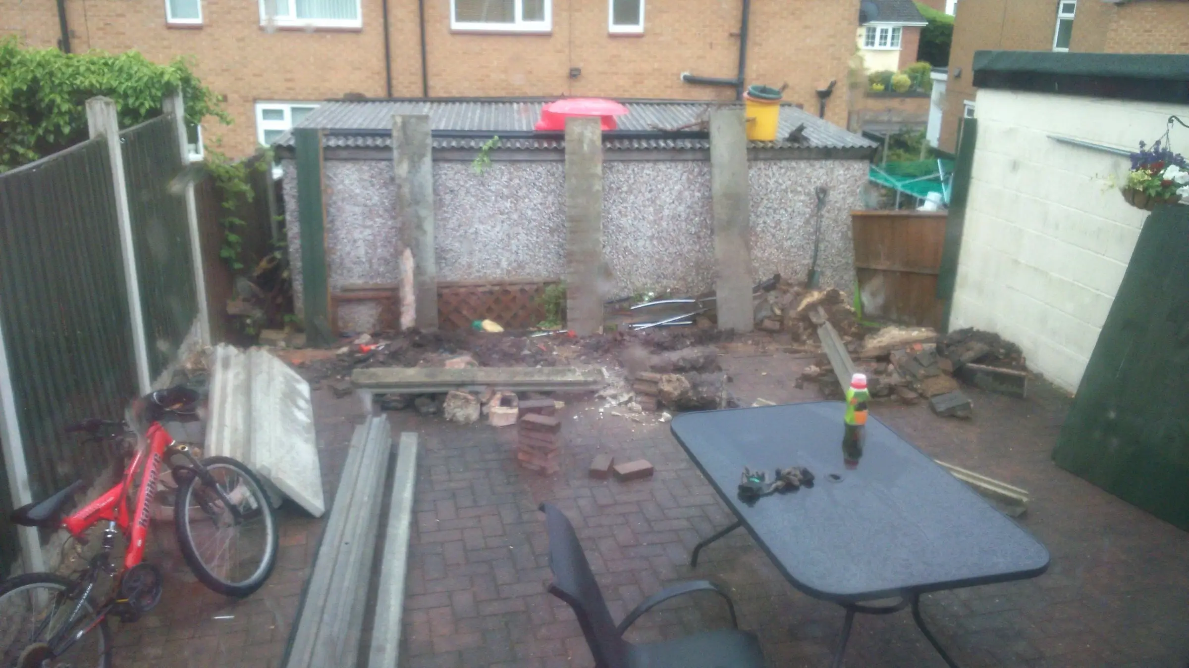 Decking with gabion detail, lawn reinstated and raised sleeper planters