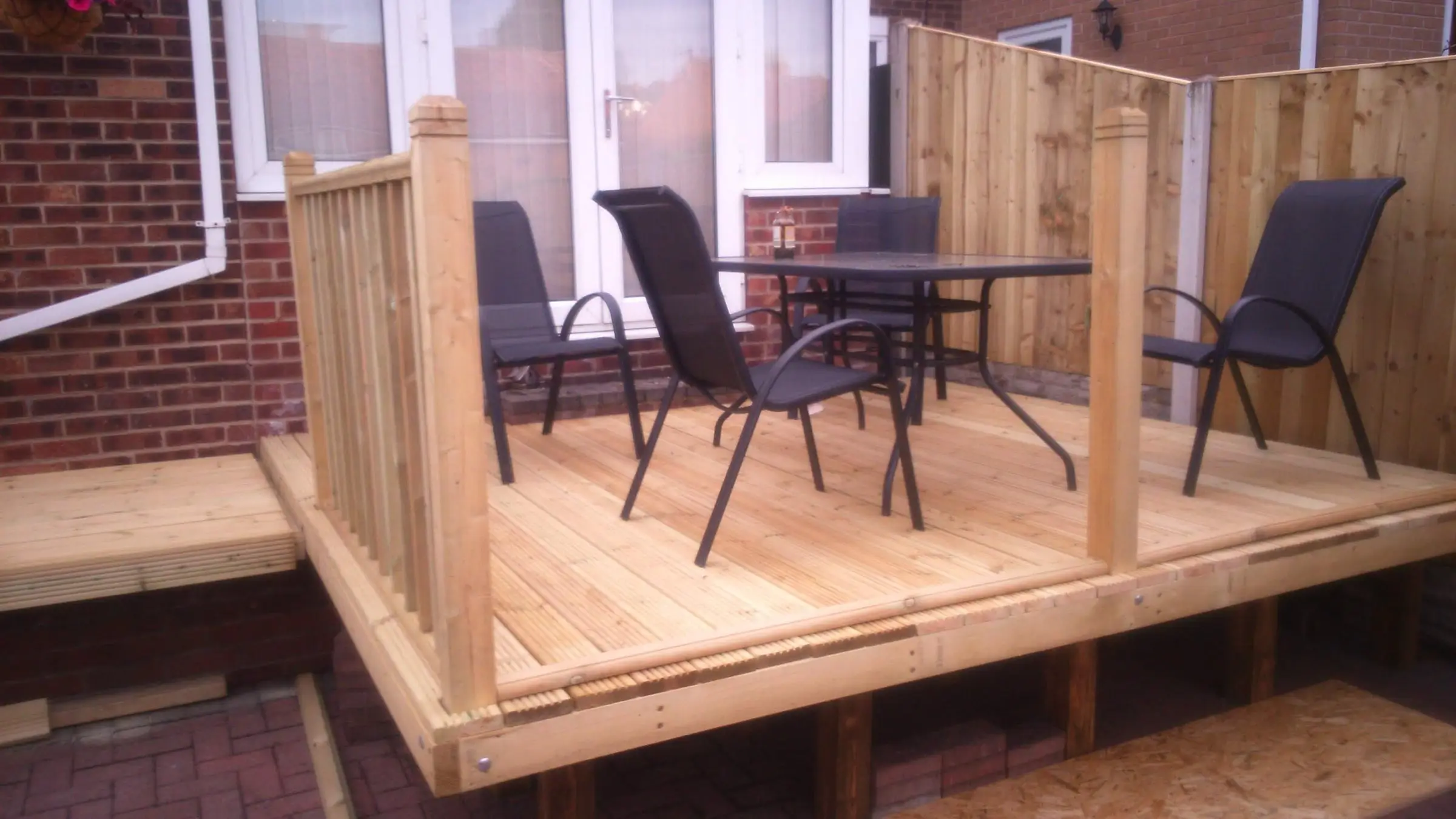 Decking with gabion detail, lawn reinstated and raised sleeper planters
