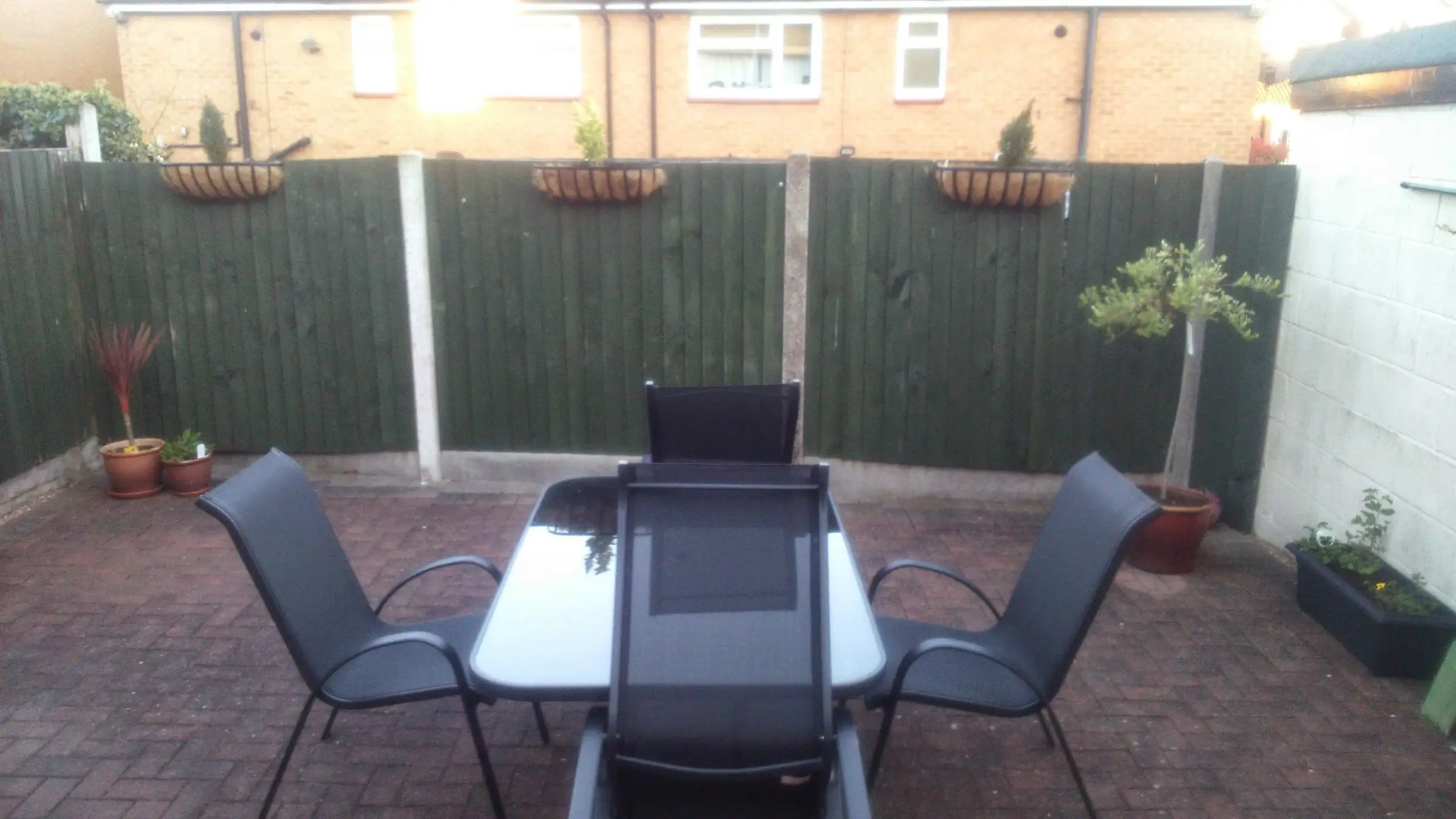 Decking with gabion detail, lawn reinstated and raised sleeper planters