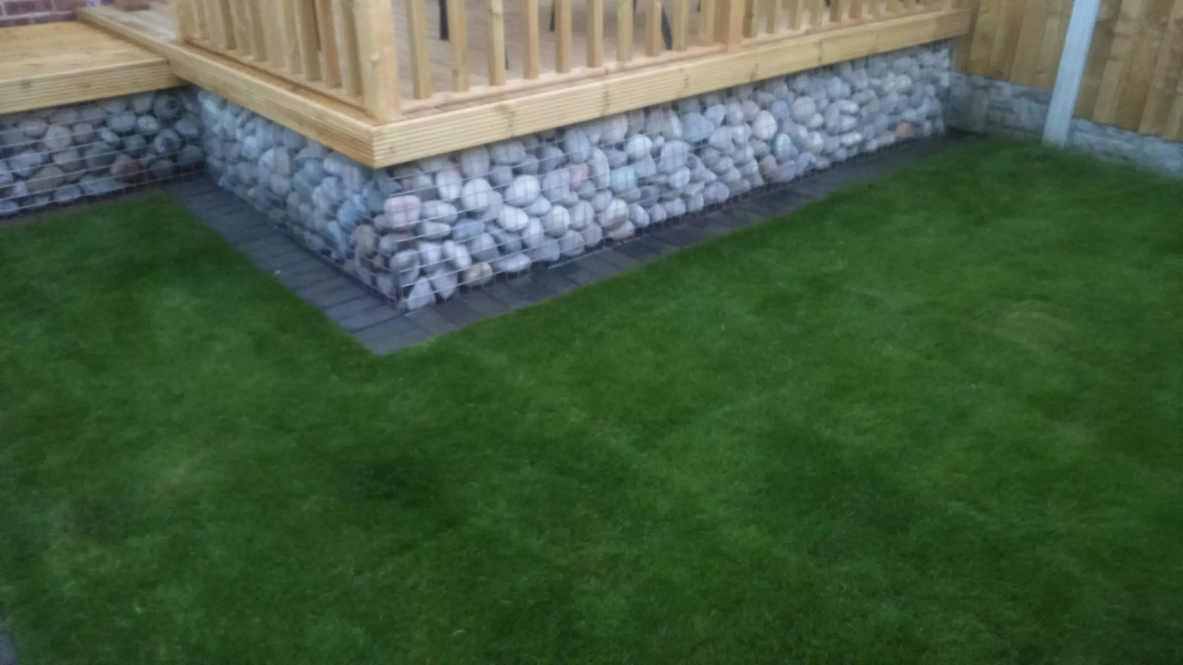 Decking with gabion detail, lawn reinstated and raised sleeper planters