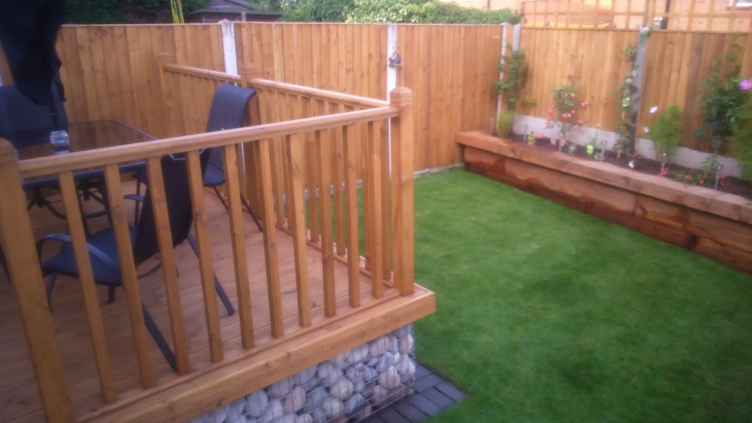 Decking with gabion detail, lawn reinstated and raised sleeper planters