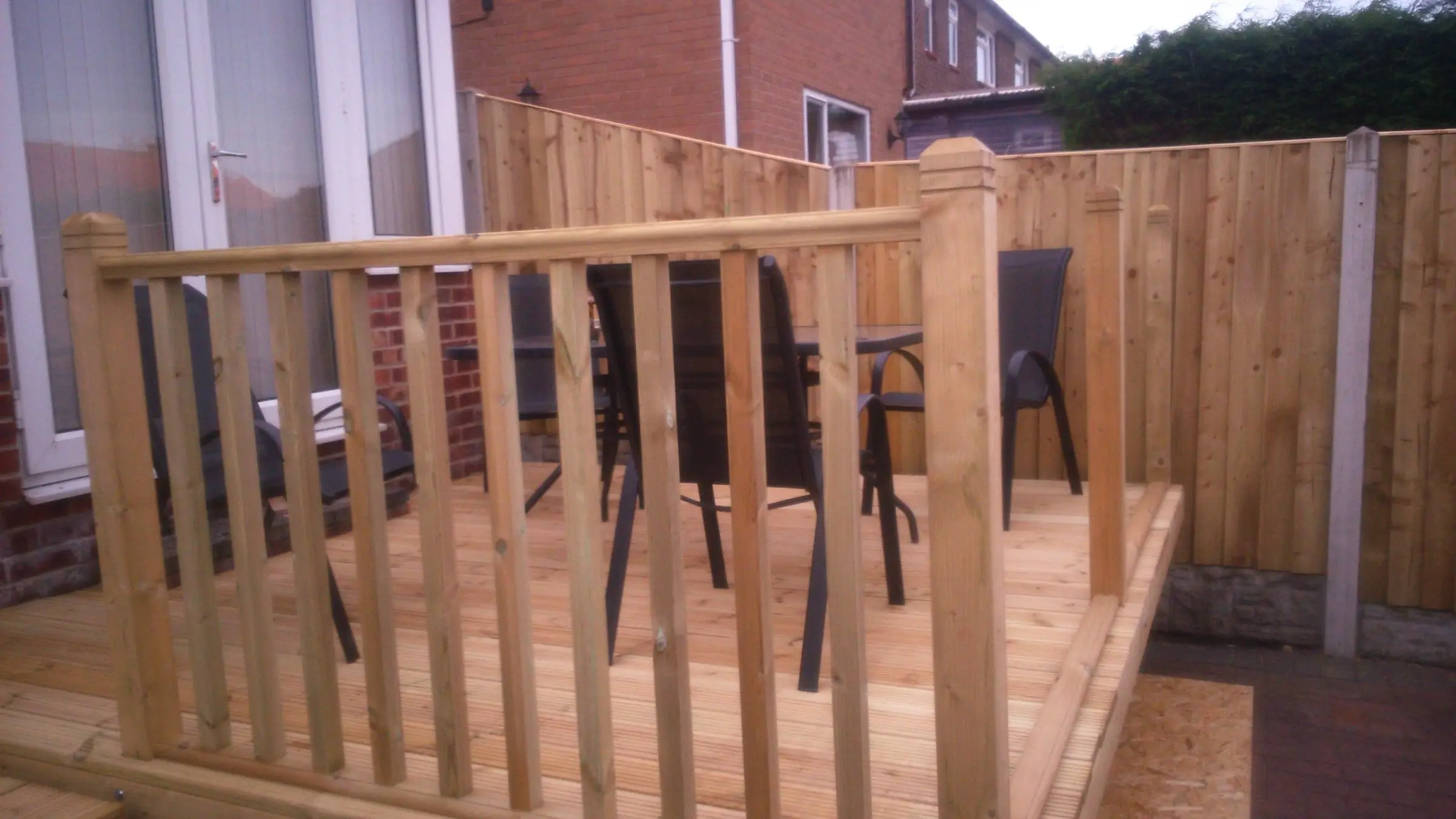 Decking with gabion detail, lawn reinstated and raised sleeper planters