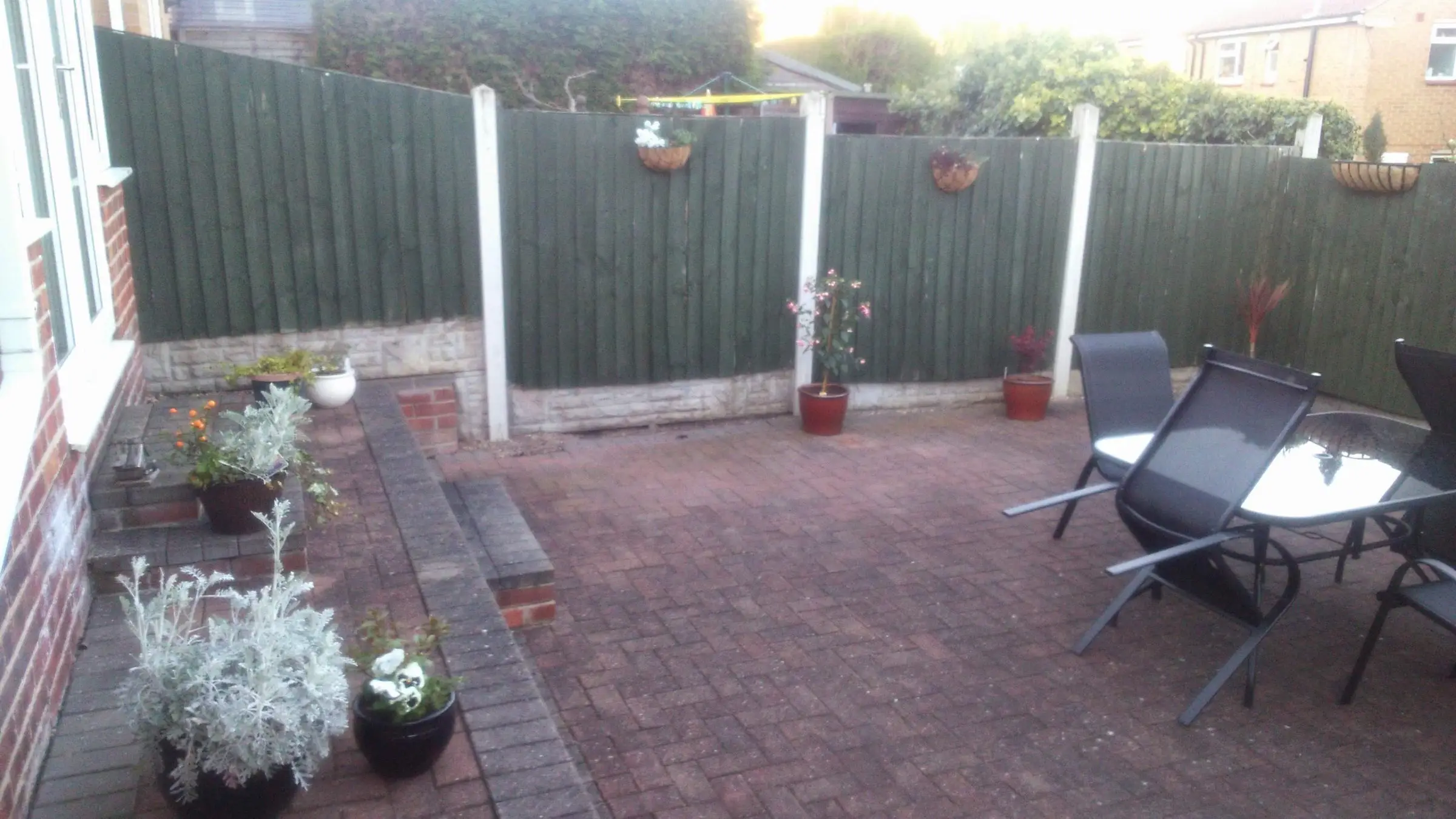 Decking with gabion detail, lawn reinstated and raised sleeper planters