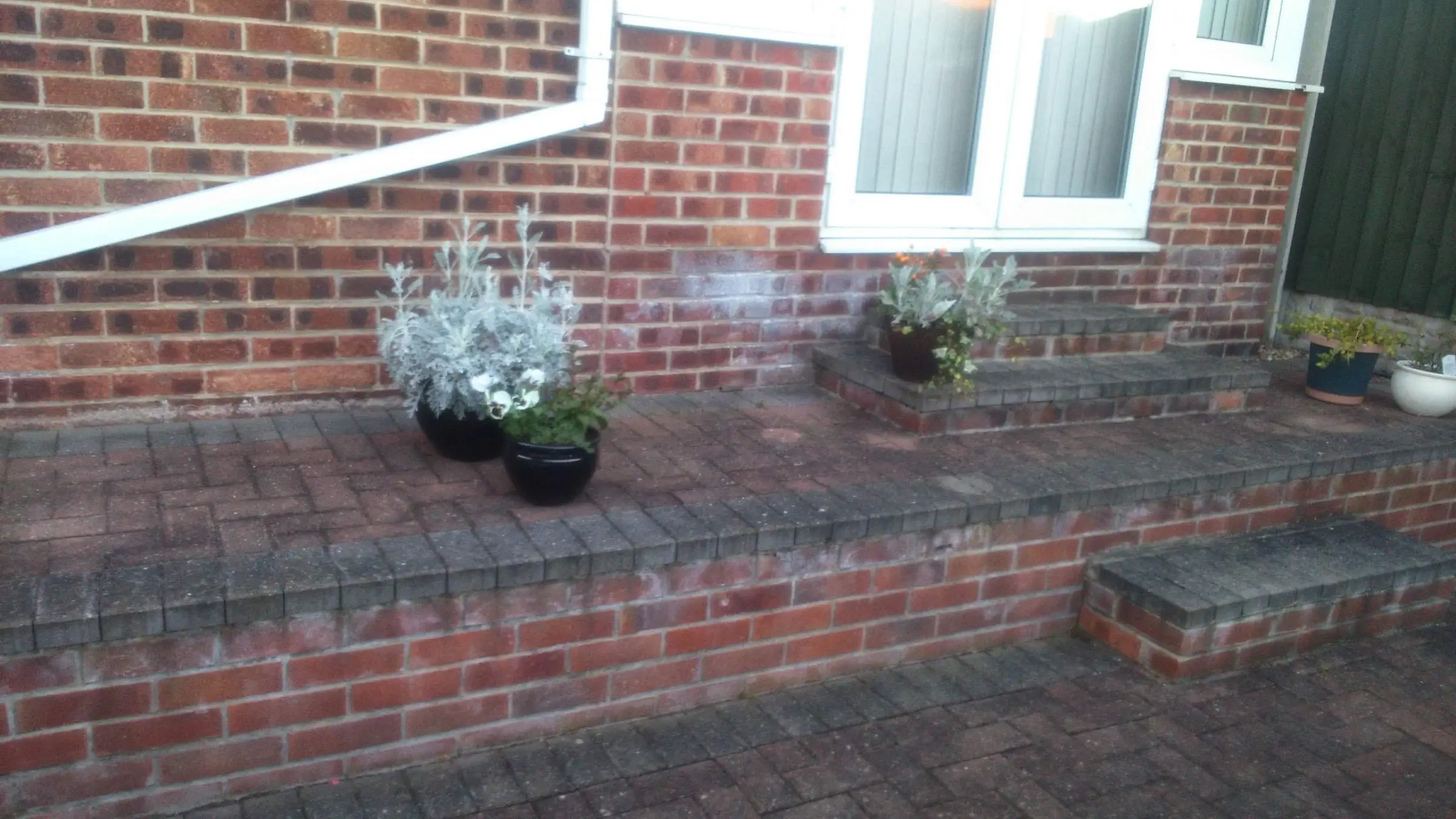 Decking with gabion detail, lawn reinstated and raised sleeper planters
