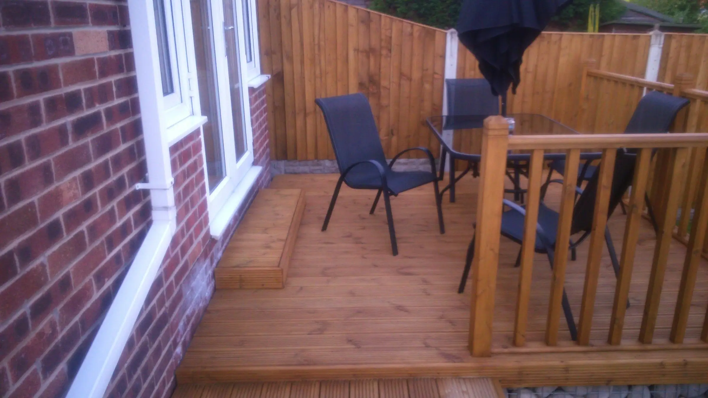 Decking with gabion detail, lawn reinstated and raised sleeper planters