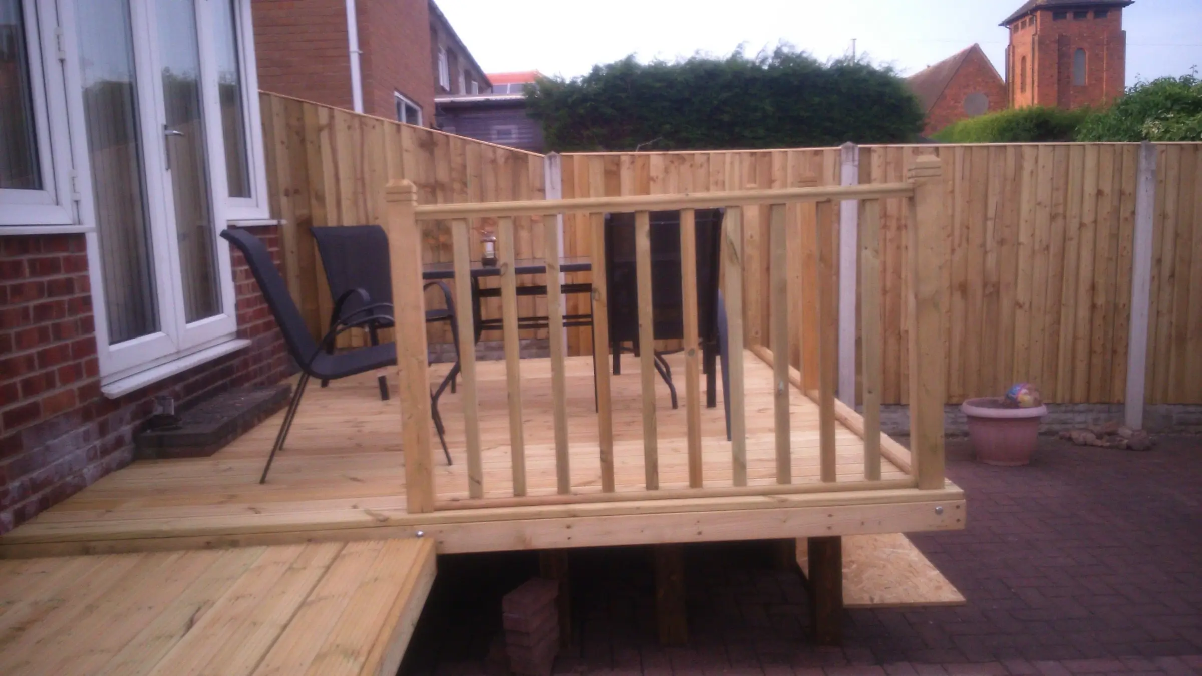 Decking with gabion detail, lawn reinstated and raised sleeper planters