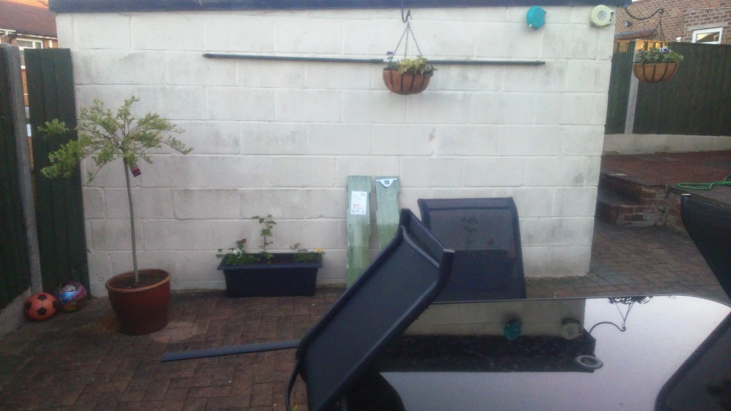Decking with gabion detail, lawn reinstated and raised sleeper planters