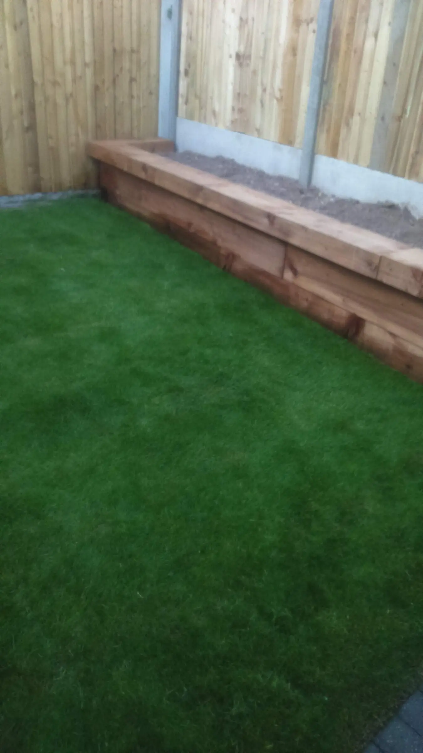 Decking with gabion detail, lawn reinstated and raised sleeper planters