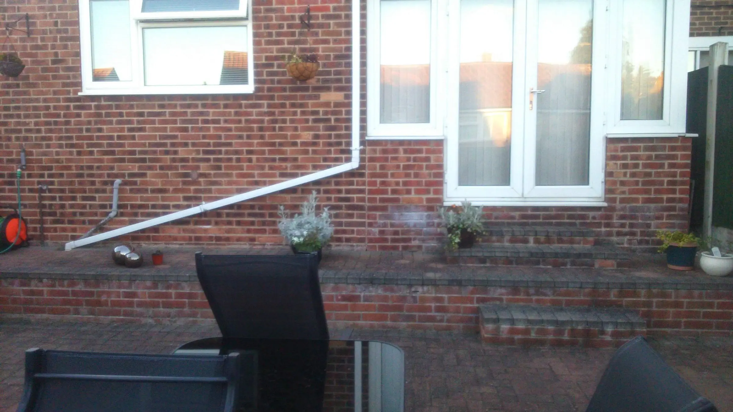 Decking with gabion detail, lawn reinstated and raised sleeper planters