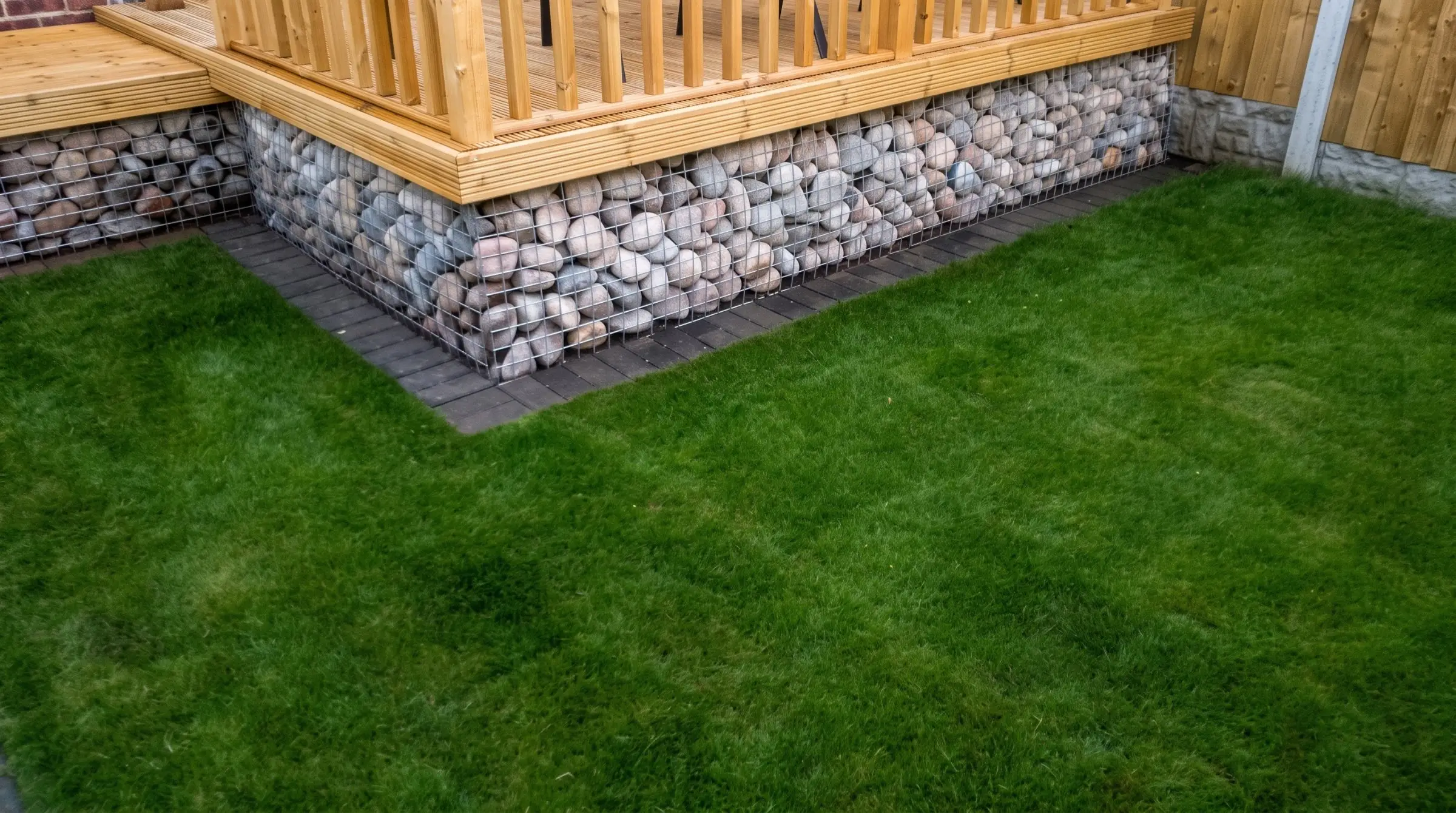 Decking with gabion detail, lawn reinstated and raised sleeper planters