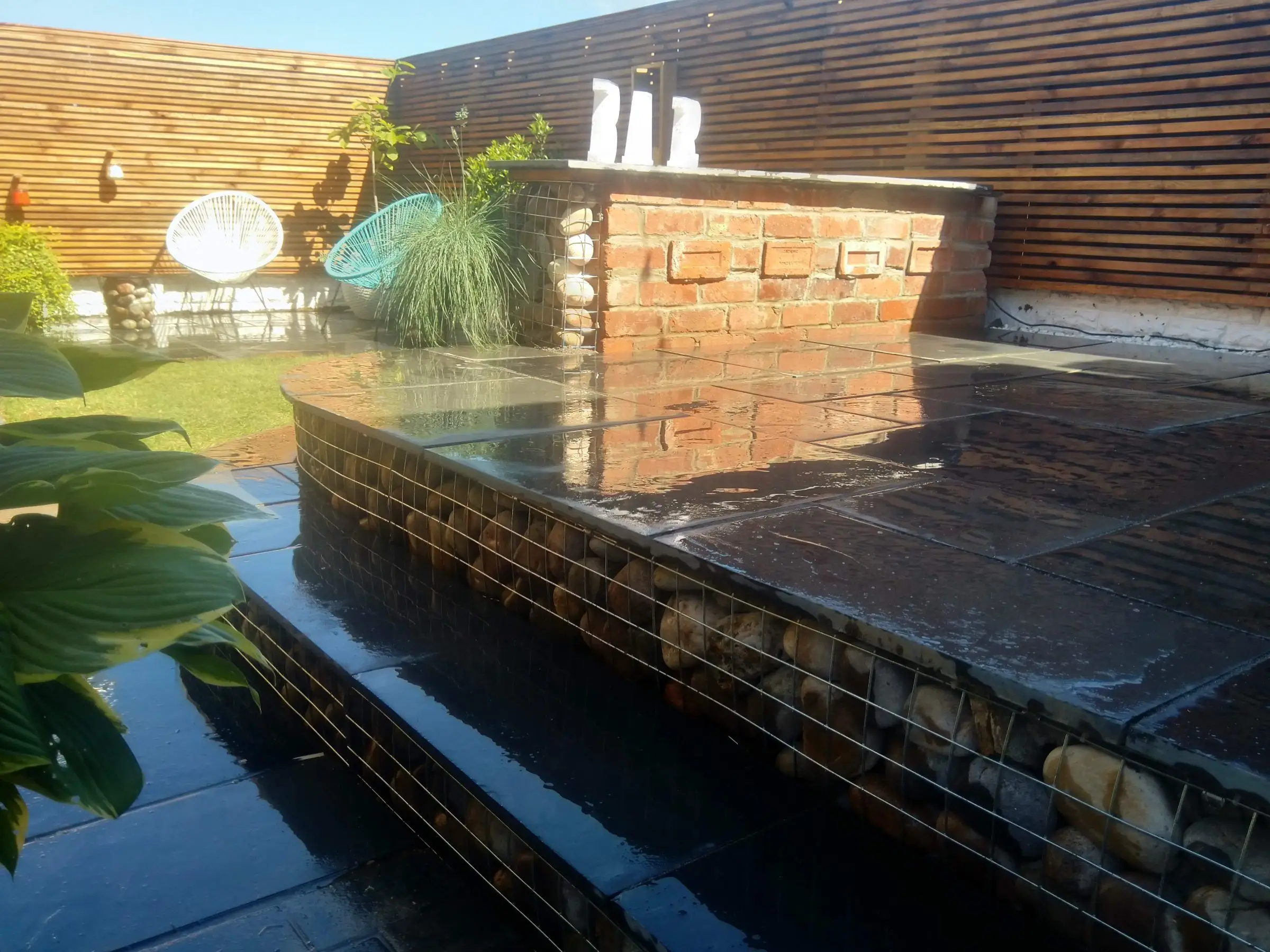 Scawsby small garden with gabion steps and water feature
