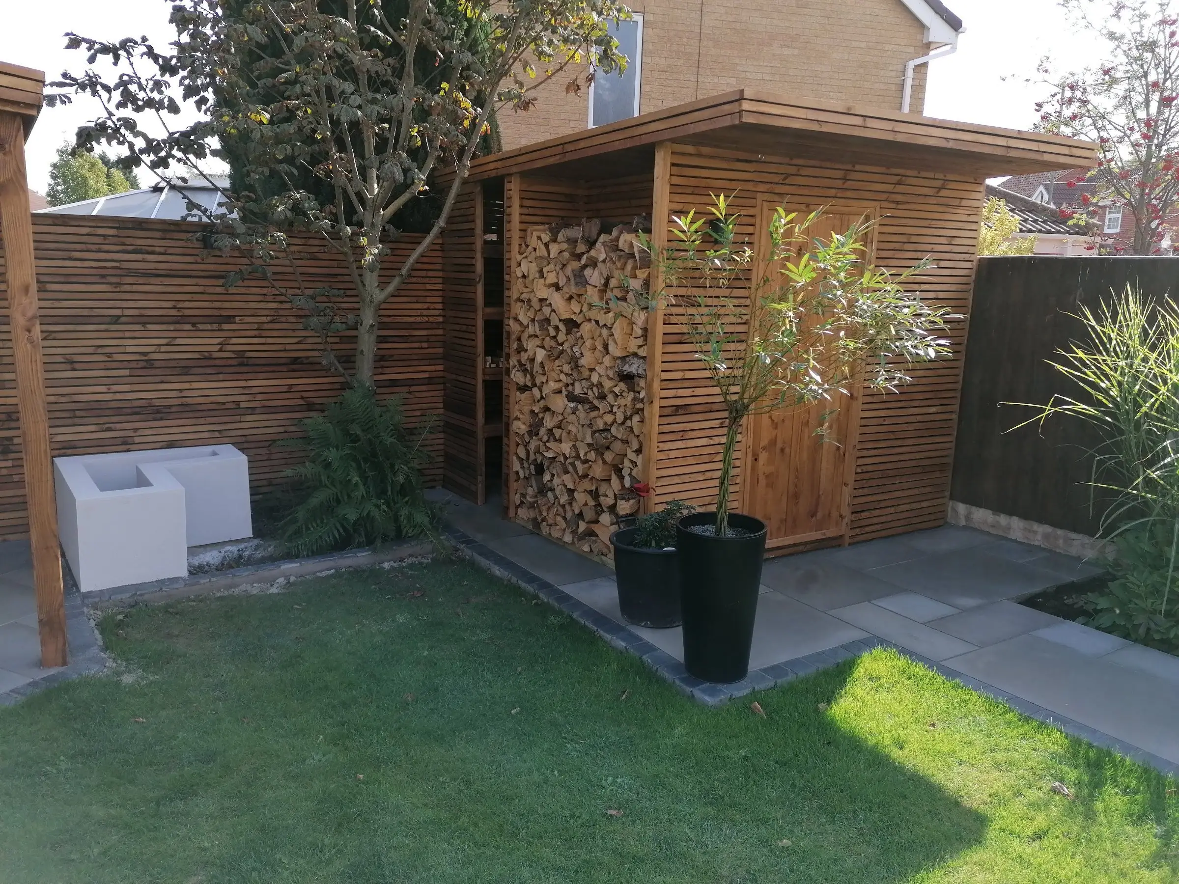 Garden redesign with bespoke timber structures and paving