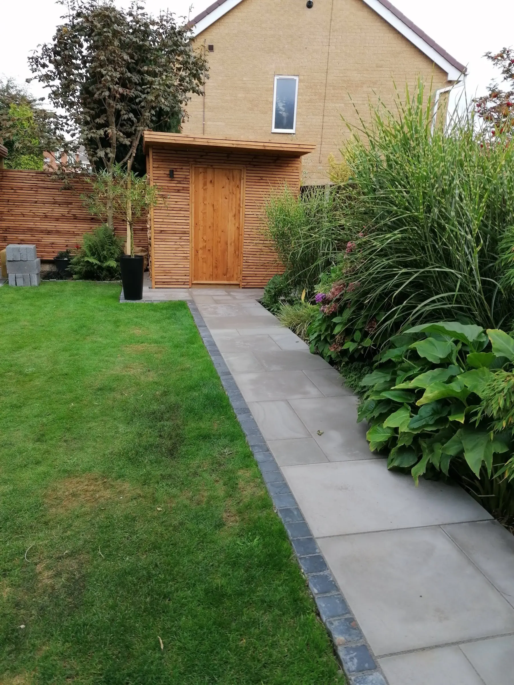 Garden redesign with bespoke timber structures and paving
