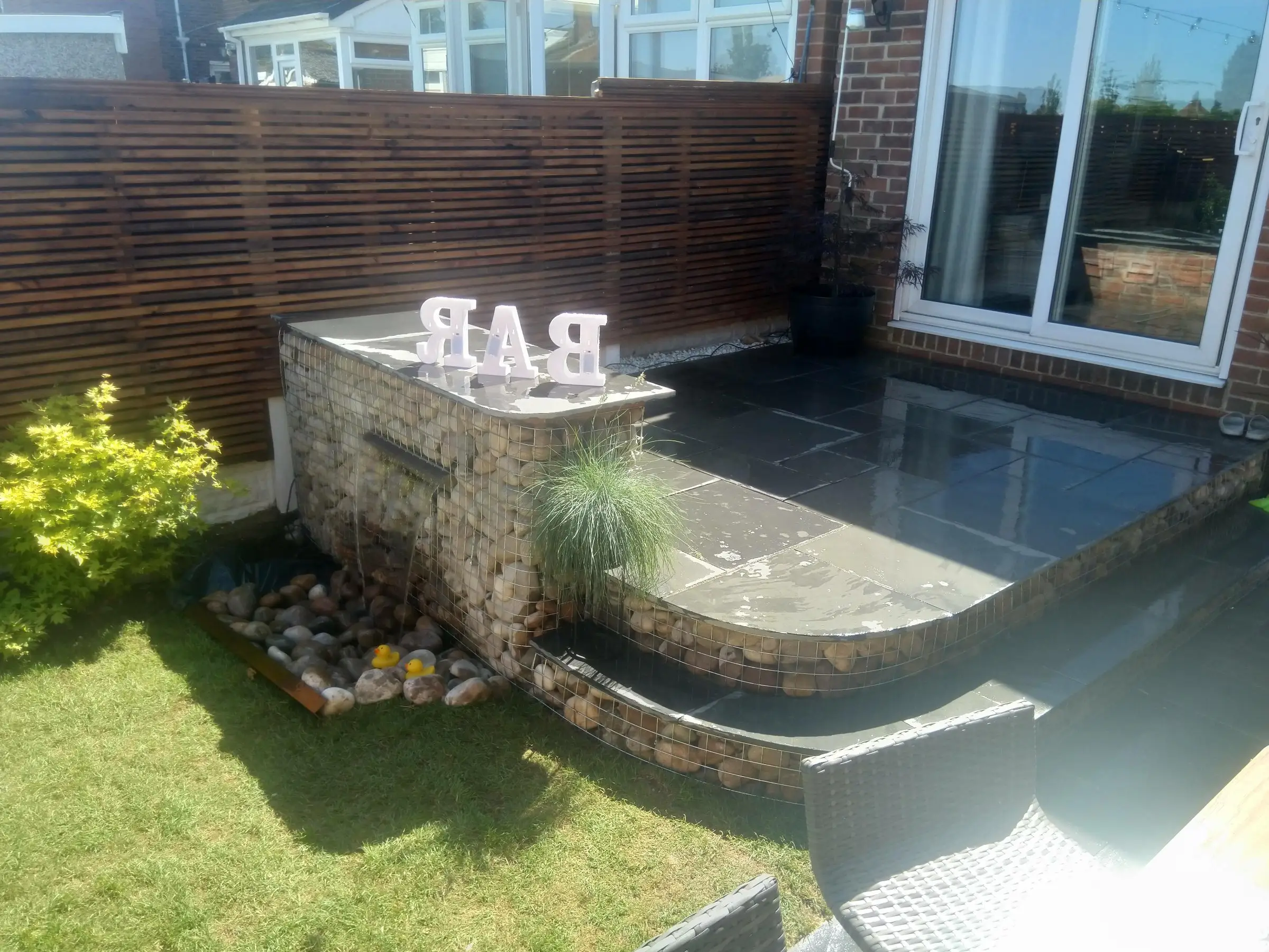 Scawsby small garden with gabion steps and water feature